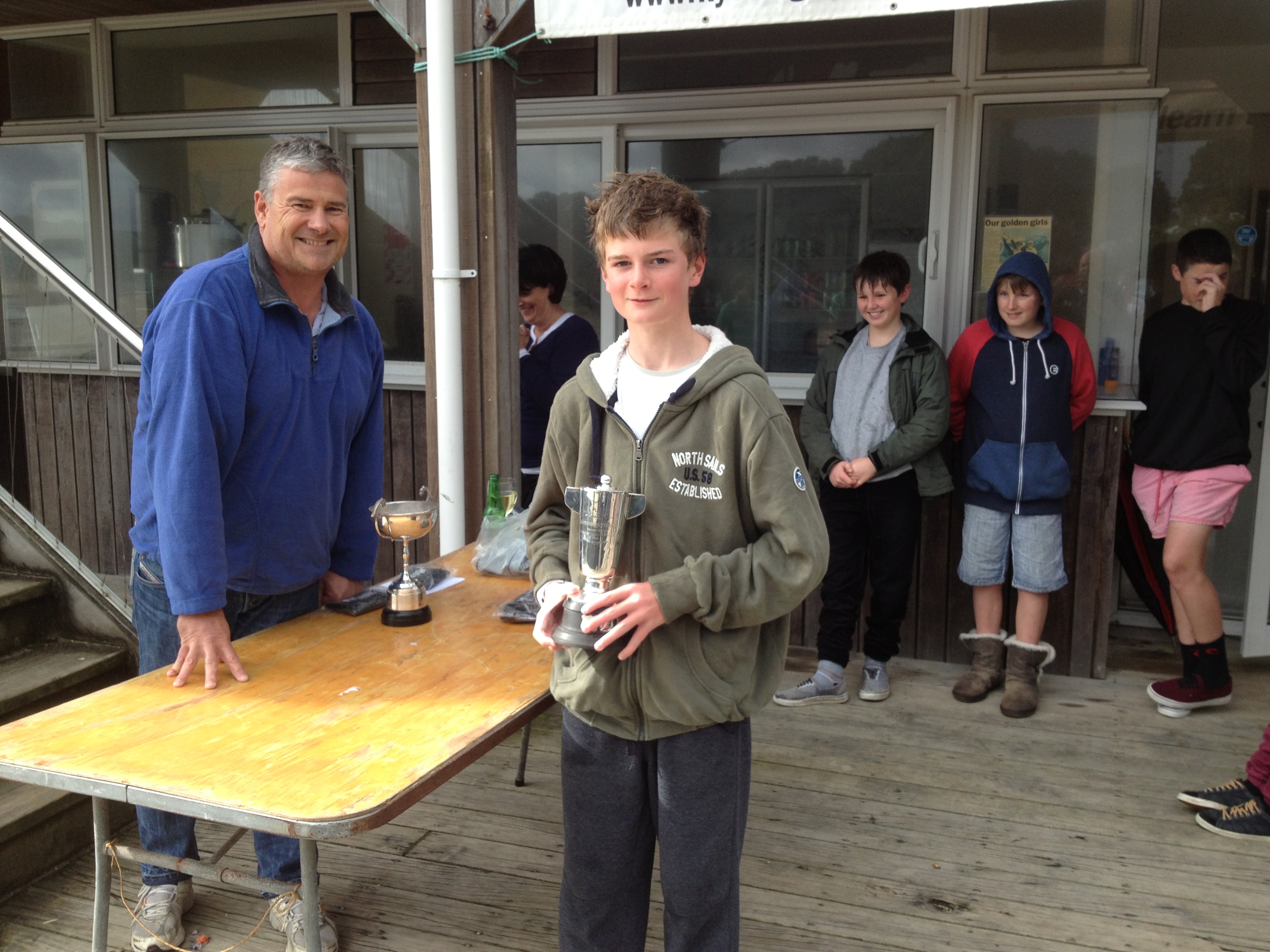 Henry Haslett receives his Auckland P Class Champ trophy from Jason Morgan Commodore KYC